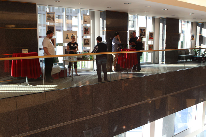 Guests view our new rotating exhibit in the One London Place Mezzanine